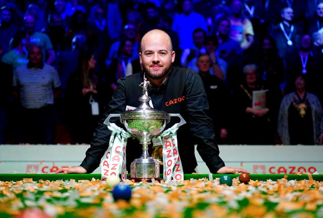 <p>Luca Brecel poses with the World Snooker Championship trophy</p>